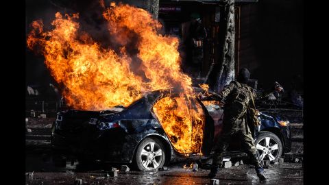 Protesters burn a car in central Kiev on February 18.