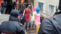 Wearing mask members of Russian punk group Pussy Riot, Nadezhda Tolokonnikova (R) and Maria Alyokhina (2dR) walk by journalists while leaving the police station of Adler, near Sochi, on February 18, 2014 after her arrest earlier in the host city of the 2014 Winter Olympics. Tolokonnikova and Alyokhina walked free after being questioned about an alleged theft from a hotel. AFP PHOTO / ANDREJ ISAKOVICANDREJ ISAKOVIC/AFP/Getty Images