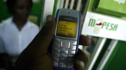 Photo taken 23 April 2007 shows a man sending money through a pioneering mobile phone service called M-Pesa, in Kenya's capital, Nairobi. M-Pesa [Pesa being swahili for money] has sky-rocketed in popularity for its low costs and convenience as users can send and receive money from remote areas through a mobile handset and at onlt a fraction of the cost of sending money through banks, courier and money transfer services. AFP PHOTO/TONY KARUMBA (Photo credit should read TONY KARUMBA/AFP/Getty Images)