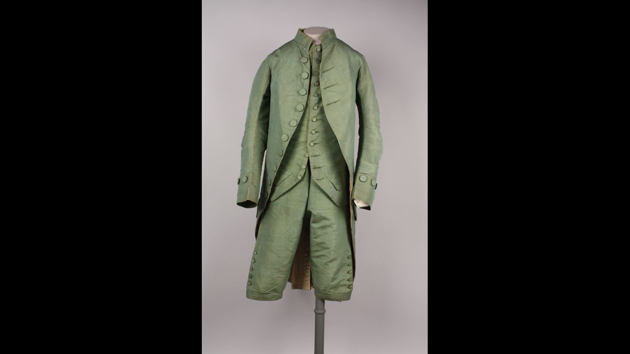For nearly two centuries, a man in America would not leave his house without wearing a complete suit. Drinking coffee -- or more likely tea or drinking chocolate -- in an 18th century cafe would have compelled a man to display an outfit of finery. This three-piece suit would have been worn by someone in the upper class.