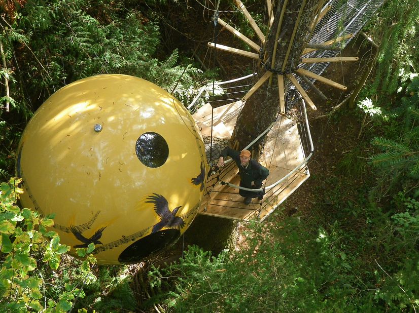 Climb rope staircases or steel bridges to access the swinging handmade orb where your bed is located at Free Spirit Spheres. Other facilities, such as a kitchen and showers, are located below on ground level.