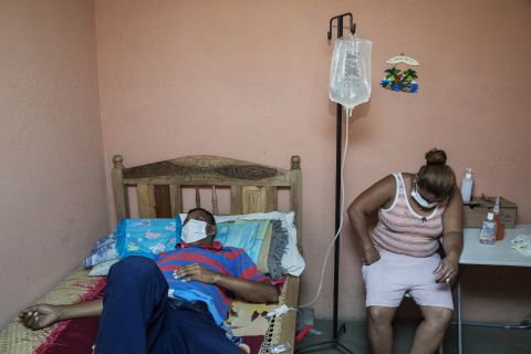 A man who worked in the sugar cane fields for decades receives dialysis at home with his daughter. He and his 24-year-old son, who worked in the fields for just five years, are both suffering from kidney disease. The names of the victims and their families are being withheld due to the ongoing tension about the prevalence of the disease.