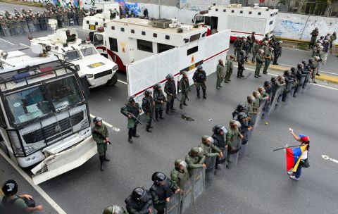 A protester confronts the National Guard as they block the path leading to downtown Caracas on February 18.