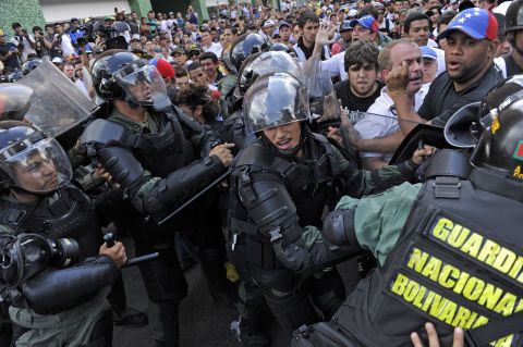 Protesters clash with the National Guard during demonstrations in Caracas on February 18.