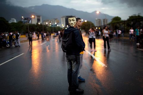 Demonstrators stand on a highway during a protest outside La Carlota airport in Caracas on February 18.
