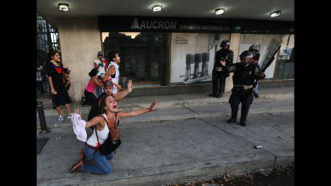 A demonstrator shouts for riot police not to fire tear gas in Caracas on Saturday, February 15.