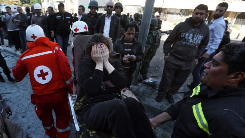 Red Cross workers carry a wounded woman away after an explosion in Beirut on February 19.