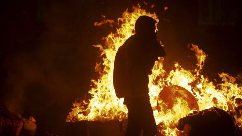 Lopez supporters light fires in the streets of Caracas on February 18.