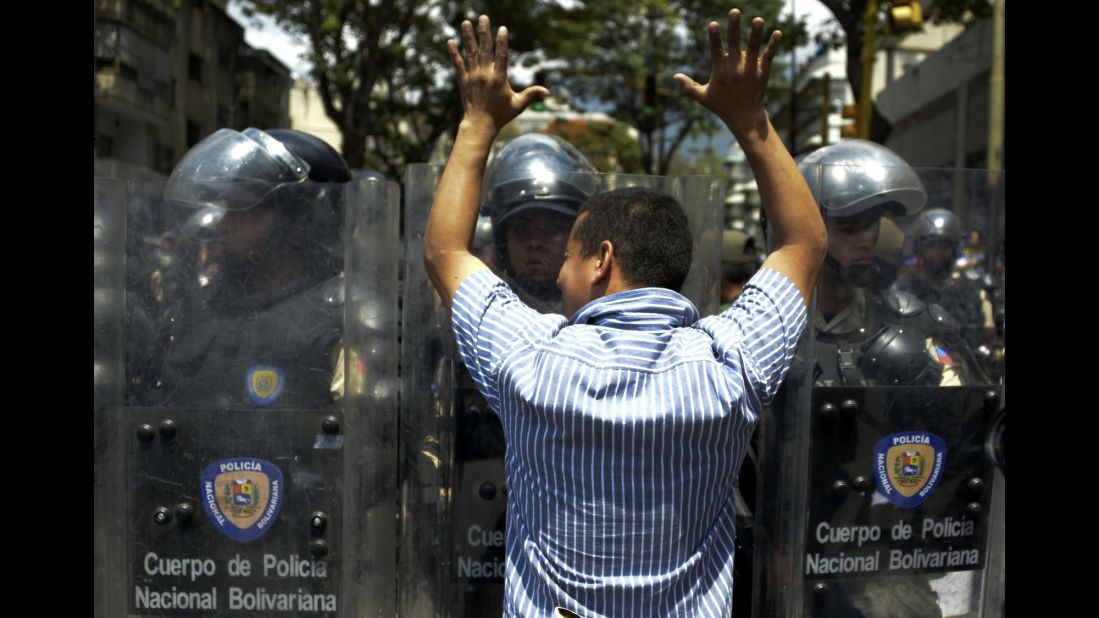 A protester faces riot police February 18 during a march in Caracas.