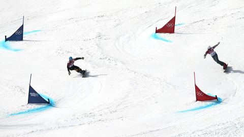 Snowboarders Alexander Bergmann of Germany, left, and Rok Flander of Slovenia compete in the parallel giant slalom on February 19.