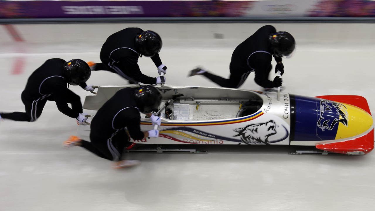 The Romanian four-man bobsled team starts a run during a training session on February 19.