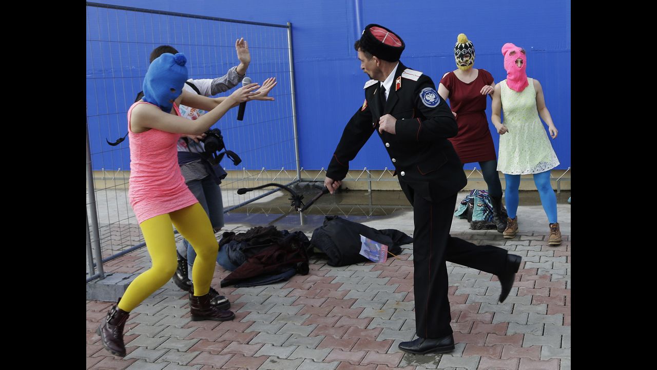 A video appeared to show security officials beating two members of the punk rock protest band Pussy Riot. Two members were held by police just miles from the Olympic Park.