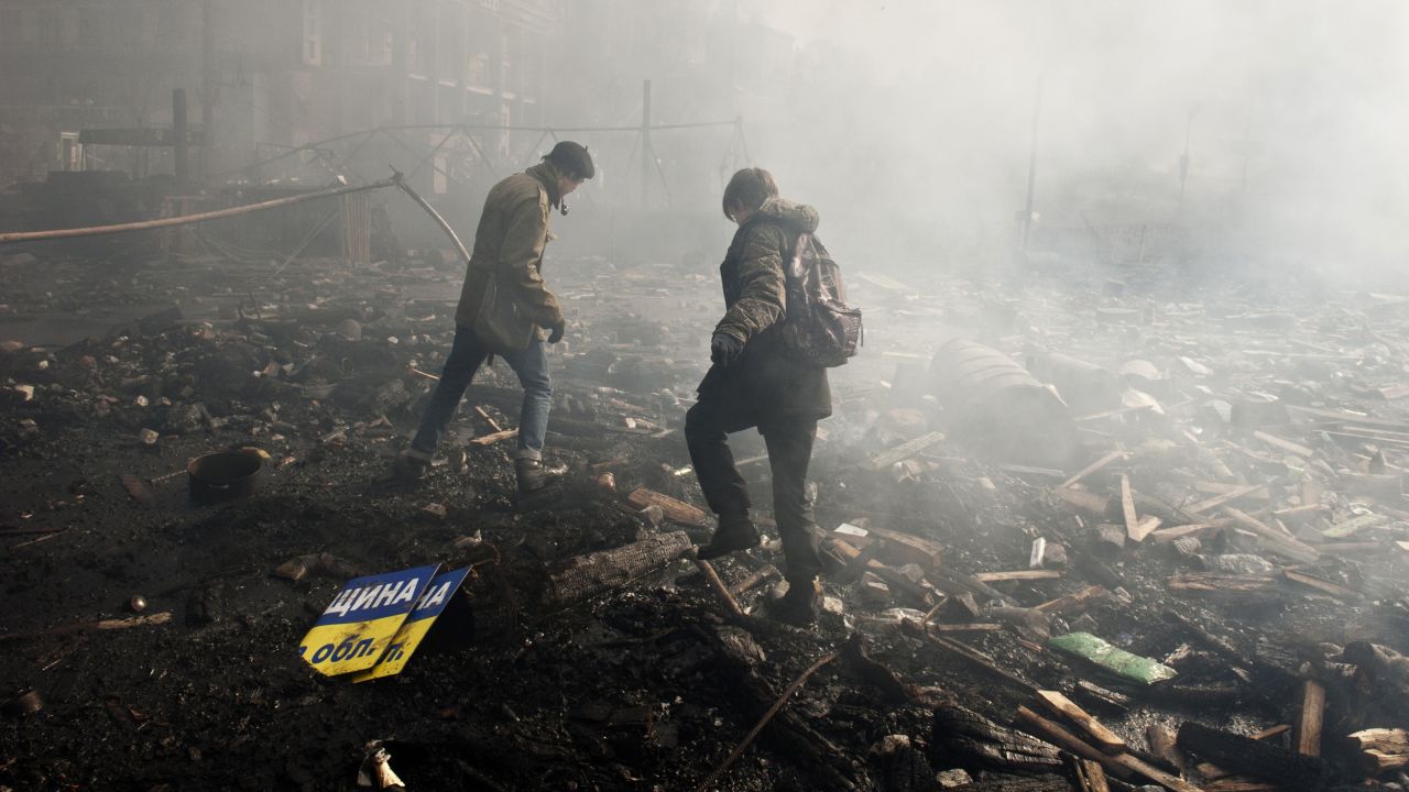 Protesters walk in the rubble of Independence Square on February 19.