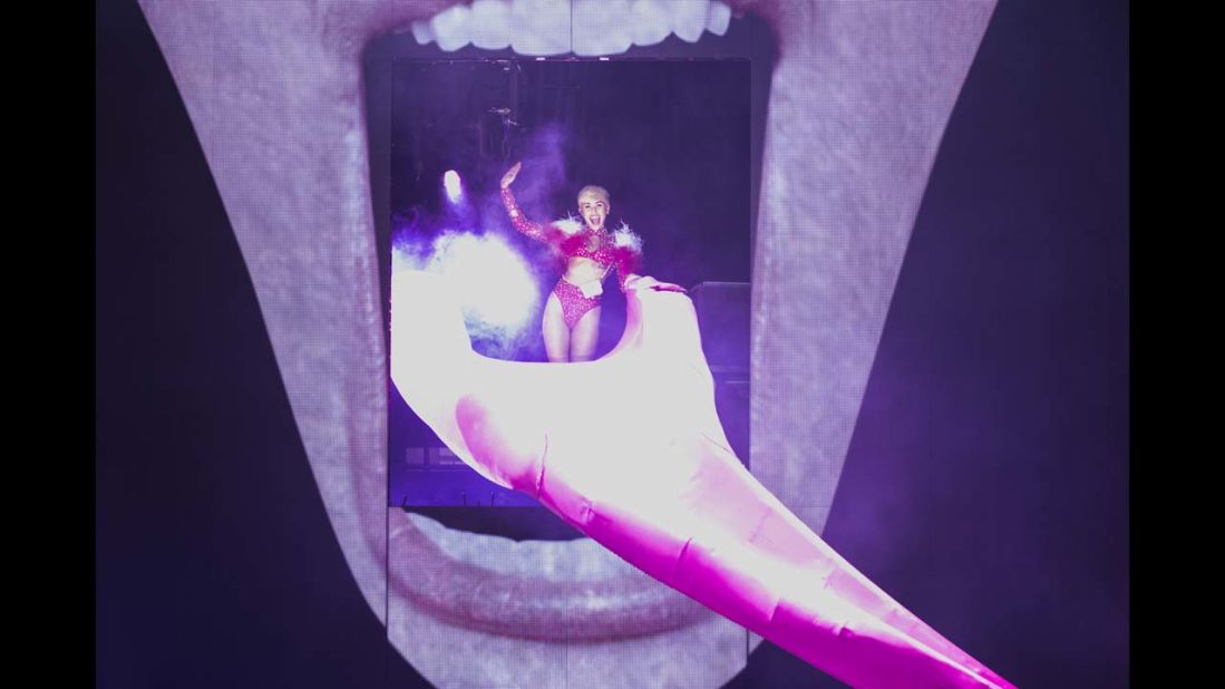 Cyrus opens her Bangerz Tour on February 14, 2014 in Vancouver, Canada. The stage features a giant image of Cyrus' face with her signature exposed tongue serving as a slide.