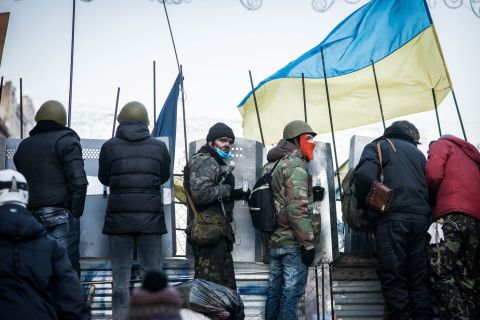 Protesters line up along barricades as Berkut police surround Maidan Nezalezhnosti, Kiev's central square, on February 18.