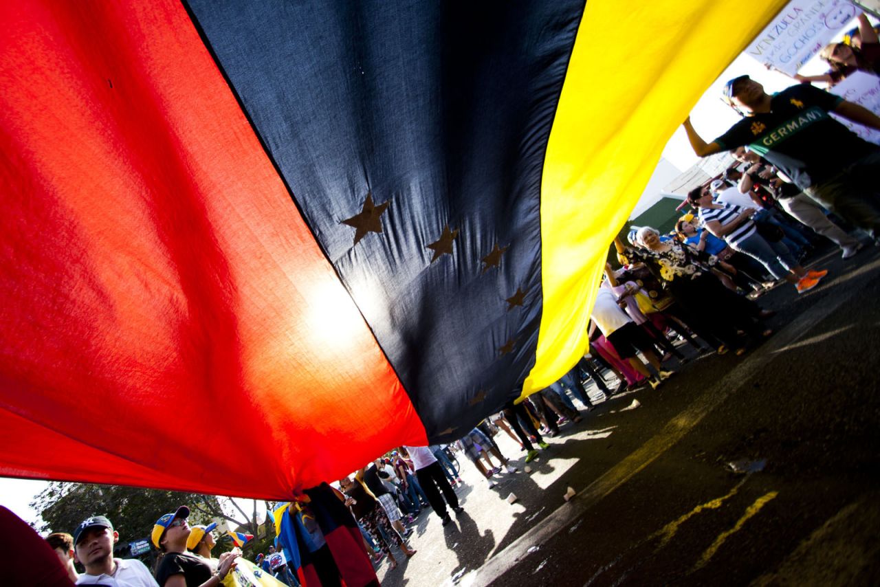 Protesters often rally with the Venezuelan flag, says <a href="http://ireport.cnn.com/docs/DOC-1086169">Roberto Carlo Rojas</a>, a professional photographer who supports the protesters. "Nothing that the government says (about the protests) is real," he said. He captured this photo on February 16 in Maracaibo.