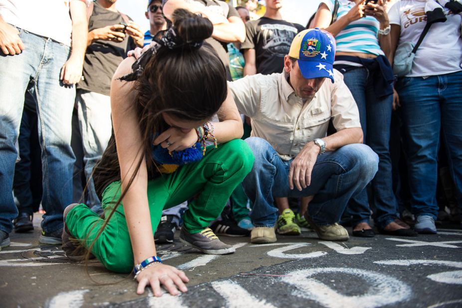 A young <a href="http://ireport.cnn.com/docs/DOC-1084811">woman cries</a> on February 13 at the spot where an opposition member was killed a day before in Caracas.