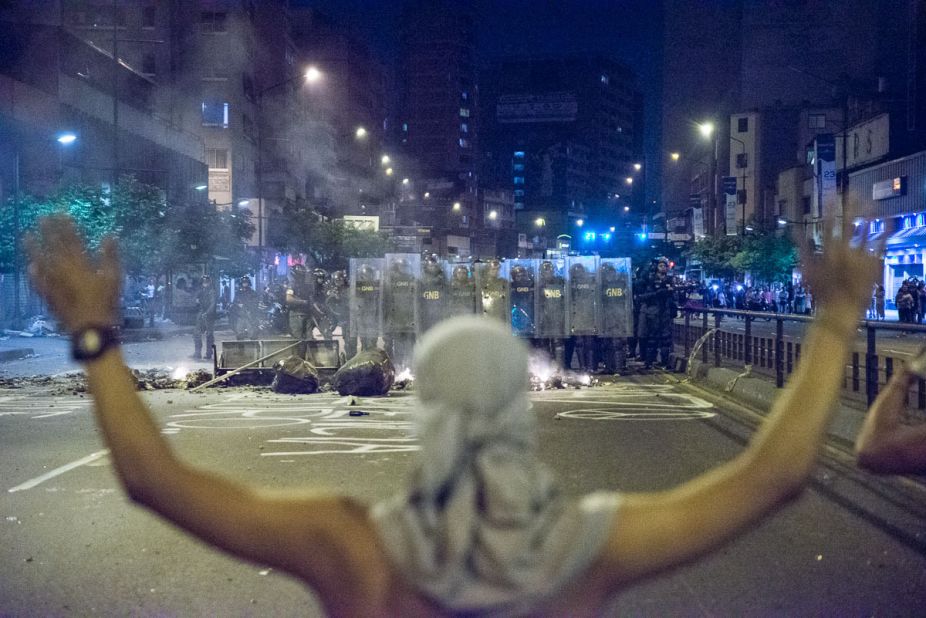 A protester in Caracas stands in front of a "piquete," a National Guard picket. Freelance photographer Carlos Becerra captured this image on February 15.