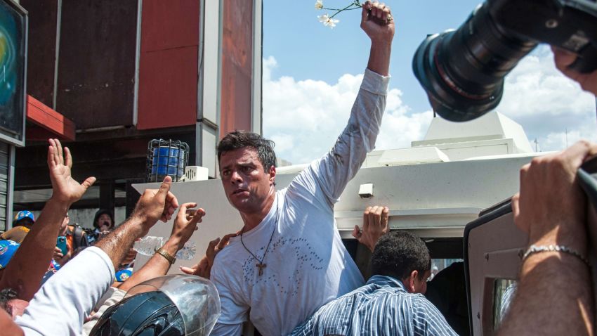 Leopoldo Lopez (C), an ardent opponent of Venezuela's socialist government facing an arrest warrant after President Nicolas Maduro ordered his arrest on charges of homicide and inciting violence, is escorted by the national guard into a vehicle after he turned himself in, during a demonstration in Caracas, on February 18, 2014. Fugitive Venezuelan opposition leader Lopez, blamed by Maduro for violent clashes that left three people dead last week, appeared at an anti-government rally in eastern Caracas and quickly surrendered to the National Guard after delivering a brief speech. AFP PHOTO / CRISTIAN HERNANDEZ        (Photo credit should read CRISTIAN HERNANDEZ/AFP/Getty Images)