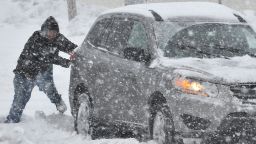 A Good Samaritan in Bethlehem, Pa., helps push a stranded motorist stuck in deep snow on Stefko Boulevard Thursday, Feb. 13, 2014. A weather system arrived in Pennsylvania with the potential to be the biggest storm of an already memorable winter season.     (AP Photo/Chris Post)