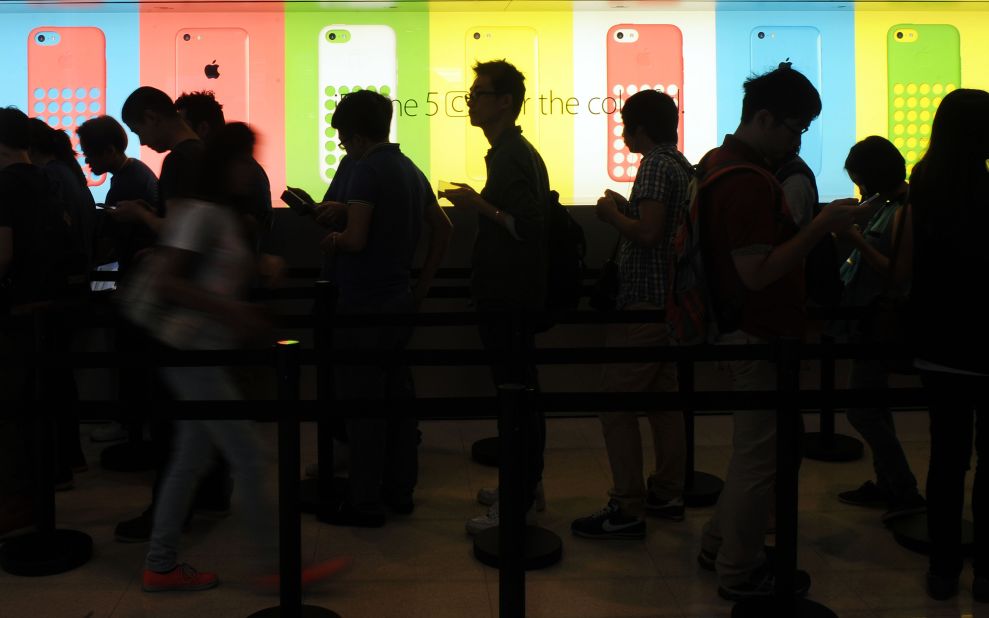 Apple broadened the acceptance of fingerprint scanning with the iPhone 5S' Touch ID sensor. In this picture, people queue outside an Apple store to purchase the new iPhone 5S and 5C in Hong Kong on September 20, 2013.