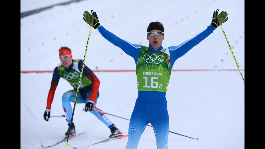 Finnish cross-country skier Sami Jauhojarvi, right, celebrates gold in the men's team sprint classic on February 19.