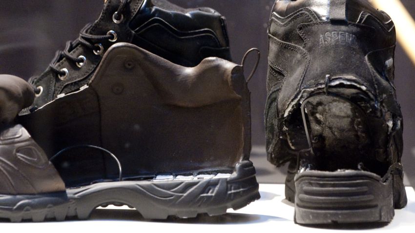 The shoes used in the failed attempt to blow up an airplane by shoe bomber Richard Reid (R) are displayed alongside an FBI model of the shoe filled with explosives, as part of a new exhibit marking the tenth annivesary of the September 11, 2001 attacks, at the Newseum in Washington, DC, as seen August 31, 2011. The exhibit, 'War on Terror: The FBI's New Focus,' illustrates the story of the FBI's changing mission after 9/11 and features more than 60 artifacts including from the first World Trade Center bombing in 1993 and pieces of the engines and landing gear of United Airlines Flight 175, which hit the South Tower of the World Trade Center. AFP PHOTO / Saul LOEB (Photo credit should read SAUL LOEB/AFP/Getty Images)