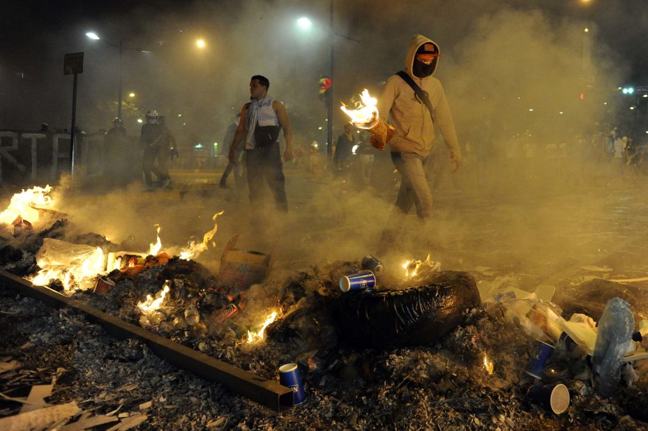 Protesters light fires during an anti-government demonstration in Caracas on Wednesday, February 19.