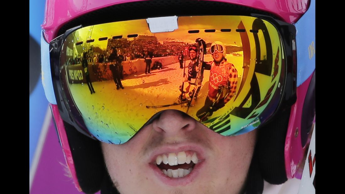 Competitors are reflected in the goggles of Sweden's John Eklund after their ski cross heat on February 20.