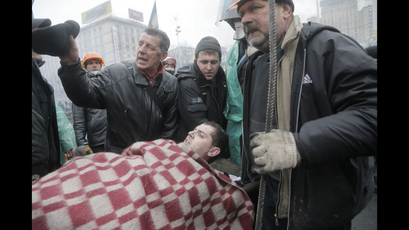 An injured protester is evacuated from Independence Square on February 20.