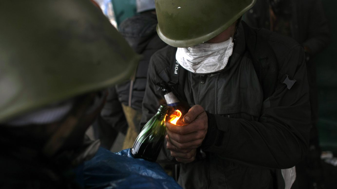 Protesters light Molotov cocktails in Kiev on February 20.