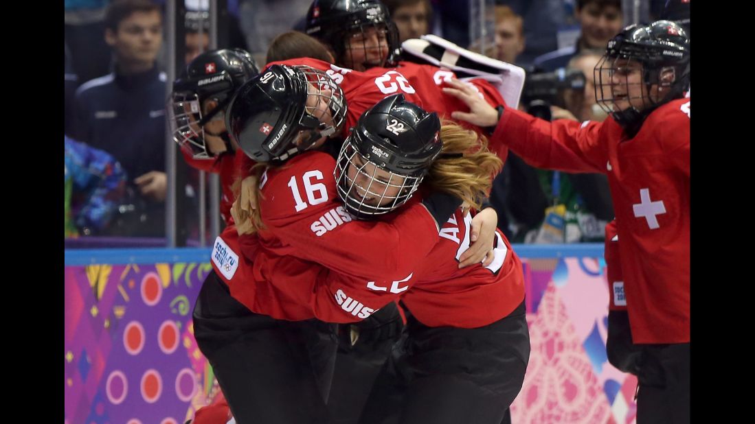 Members of the Swiss women's hockey team celebrate after defeating Sweden for the bronze medal on February 20.