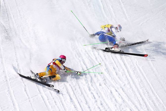 Victor Oehling Norberg of Sweden, left, and Egor Korotkov of Russia crash during the quarterfinals of the men's ski cross on February 20.