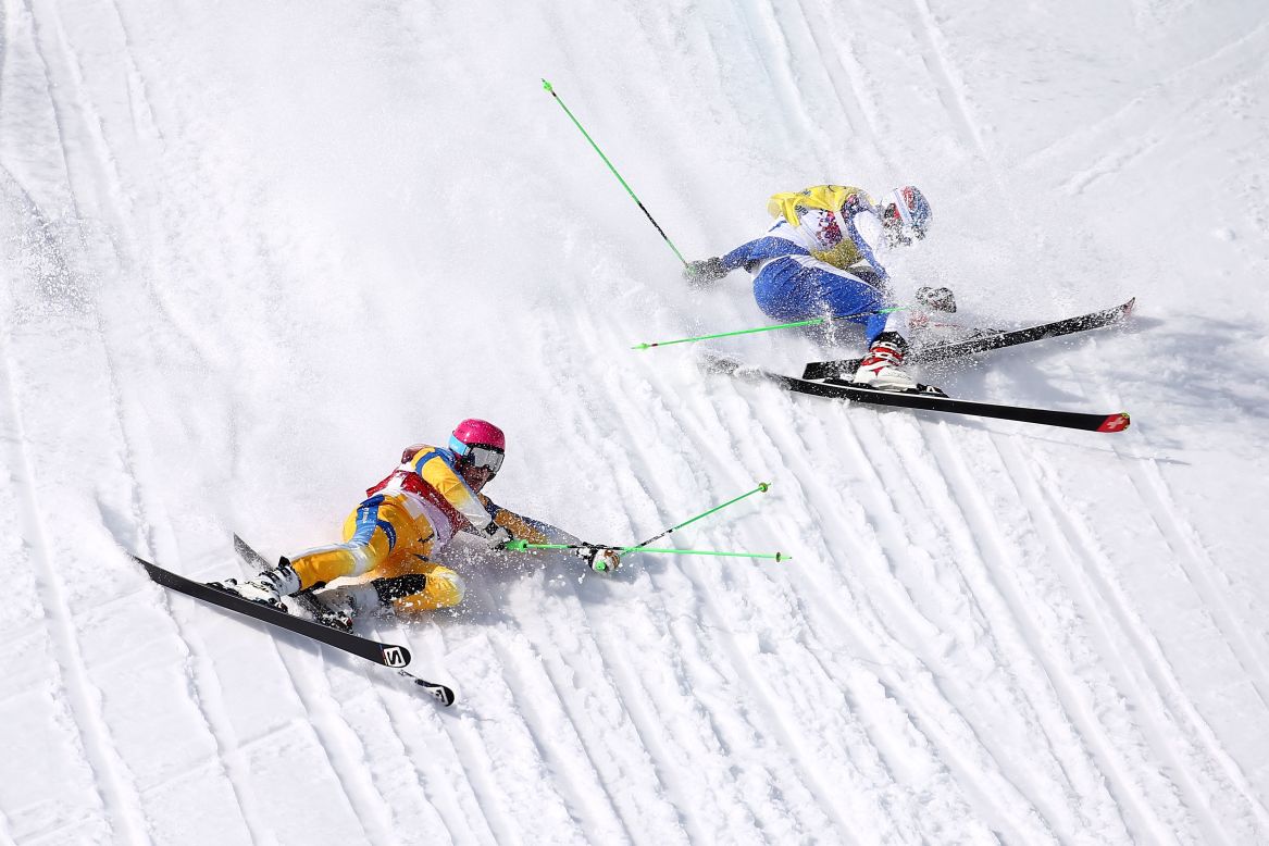 Victor Oehling Norberg of Sweden, left, and Egor Korotkov of Russia crash during the quarterfinals of the men's ski cross on February 20. 