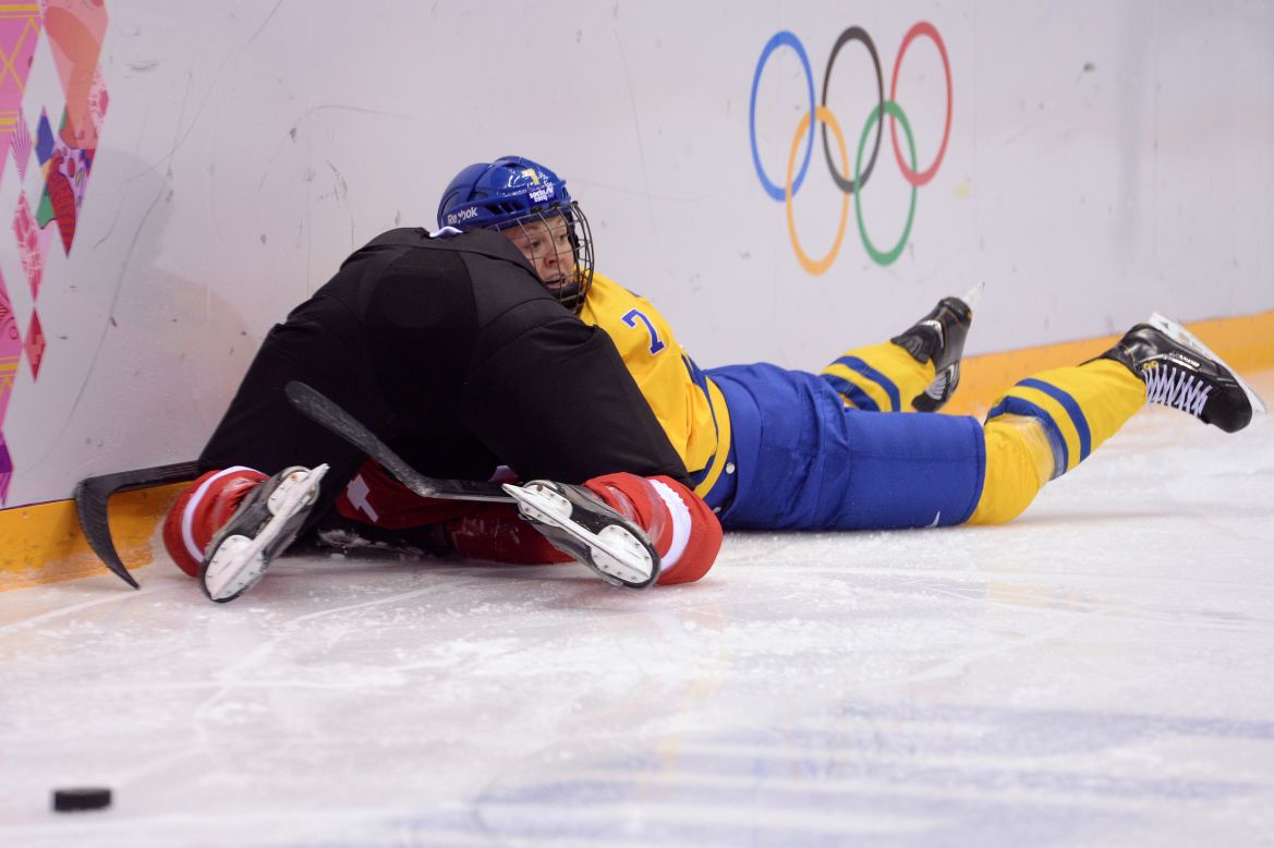 Sweden's Johanna Olofsson fights for the puck during the women's hockey game against Switzerland.