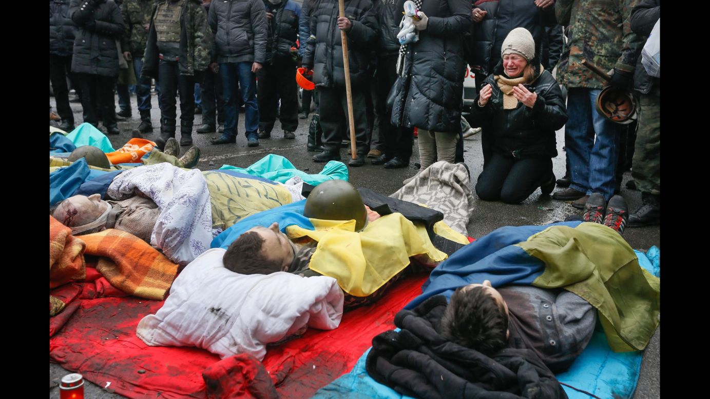 A woman on February 20 mourns over protesters who were killed during clashes.