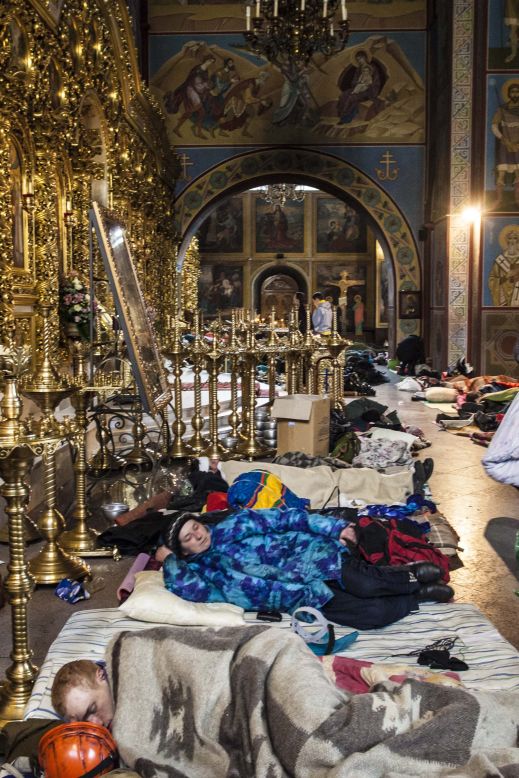An unidentified woman takes shelter in the Mykhailovsky Cathedral in Kyiv. The cathedral opened its doors for protesters wounded during the clashes with riot police Wednesday and Thursday.