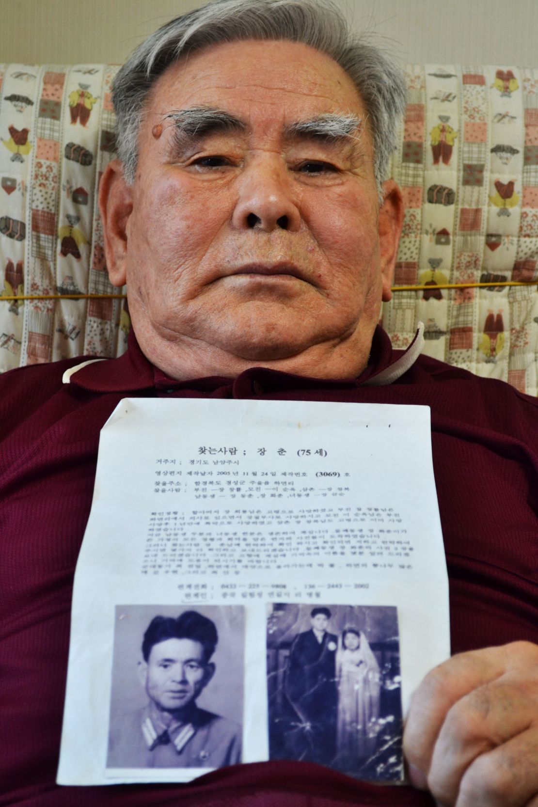 Jang Chun holds a letter and several photos of his family in North Korea through the Red Cross. 