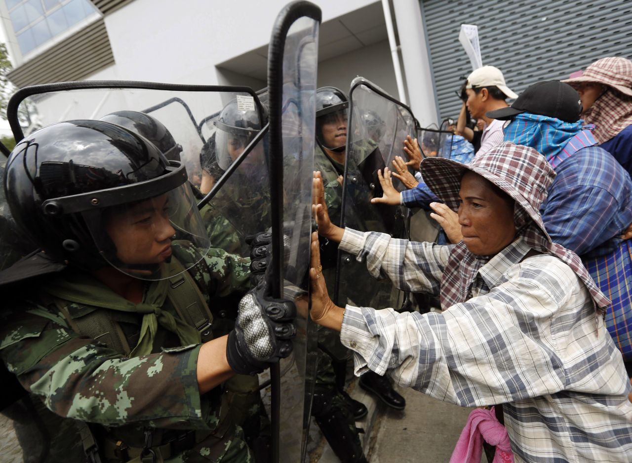 Thai rice farmers clash with security forces in Bangkok on Monday, February 17. The political crisis took on a new twist when a subsidy program that benefited rice farmers -- part of the Prime Minister's base -- was decried as corrupt by opposition leaders.