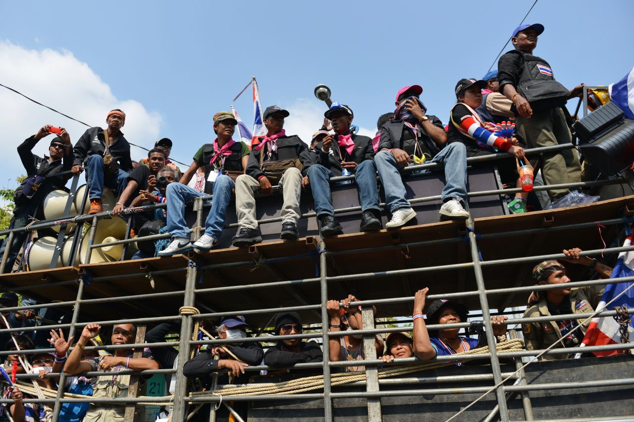 Protesters arrive at a rally outside a police headquarters in Bangkok on Friday, February 14.