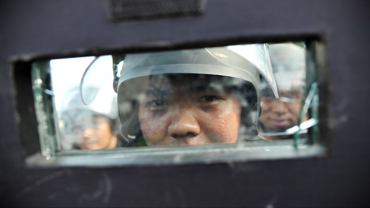 Riot police stand guard in Bangkok on February 14.