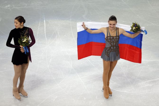Gold medalist Adelina Sotnikova of Russia, right, and silver medalist Yuna Kim of South Korea take part in the flower ceremony after the women's free skating program in Sochi, Russia, on Thursday, February 20. Some are questioning the scores given to the skaters since Kim seemingly had a better overall performance.
