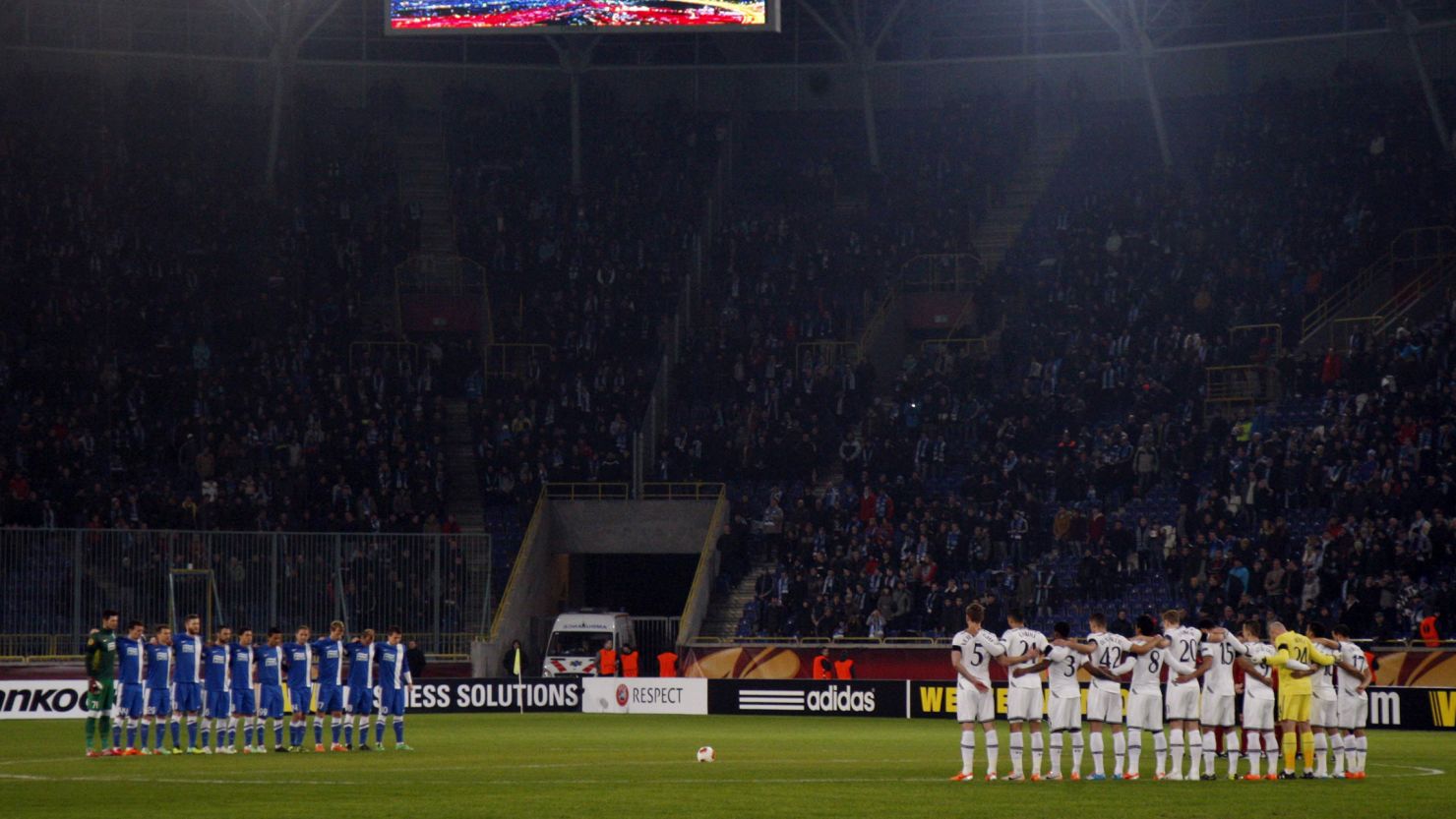 Spurs and FC Dnipro players line the center circle to observe a minute's silence before Thursday's Europa League tie. 