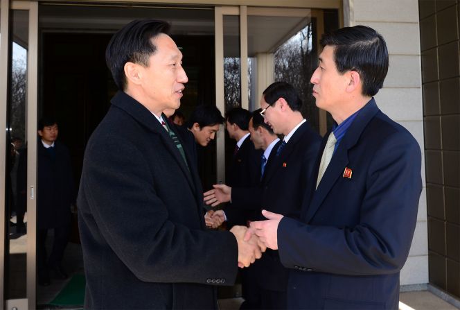 Lee Duk-Haeng (L), the head of South Korea's family reunion delegation, shakes hands with his North Korean counterpart Park Yong-Il (R) after their meeting on February 5, 2014 in Panmunjom, North Korea. Trust remains tenuous in the peninsula.