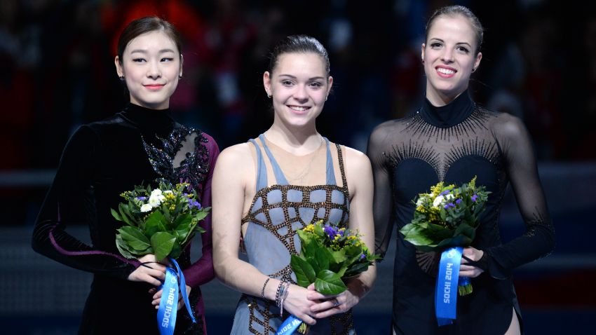 (From L) South Korea's silver medalist Kim Yu-Na, Russia's gold medalist Adelina Sotnikova and Italy's bronze medalist Carolina Kostner pose on the podium during the Women's Figure Skating Flower Ceremony at the Iceberg Skating Palace during the Sochi Winter Olympics on February 20, 2014.  AFP PHOTO / YURI KADOBNOV        (Photo credit should read YURI KADOBNOV/AFP/Getty Images)