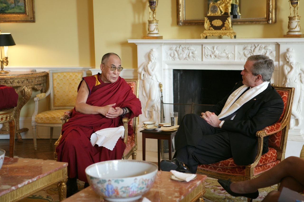 President George W. Bush, wears a scarf that was presented to him by the Dalai Lama at the White House in November 2005.