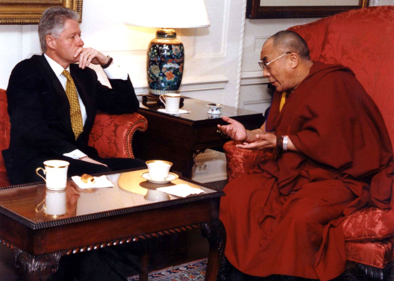 President Bill Clinton listens to the Dalai Lama during a meeting in November 1998 at the White House.
