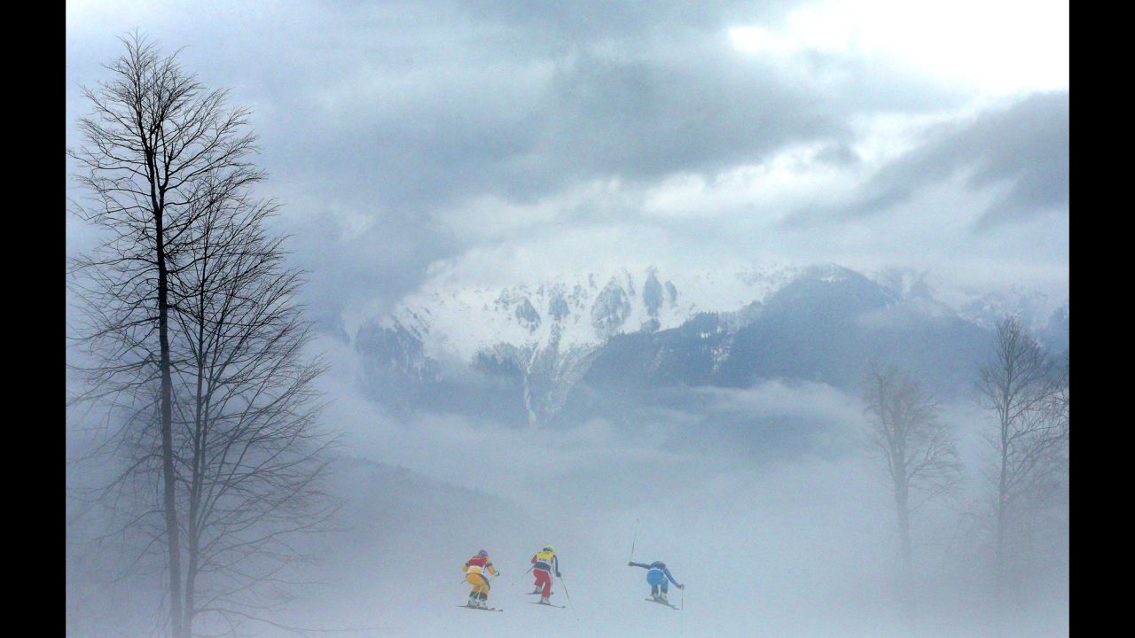 Athletes compete in heavy fog during the women's ski cross quarterfinals on February 21.