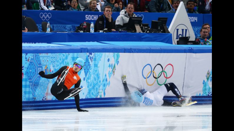 Short track speedskaters Freek van der Wart of the Netherlands, left, and Vladimir Grigorev of Russia fall to the ice in the 500-meter quarterfinals on February 21.