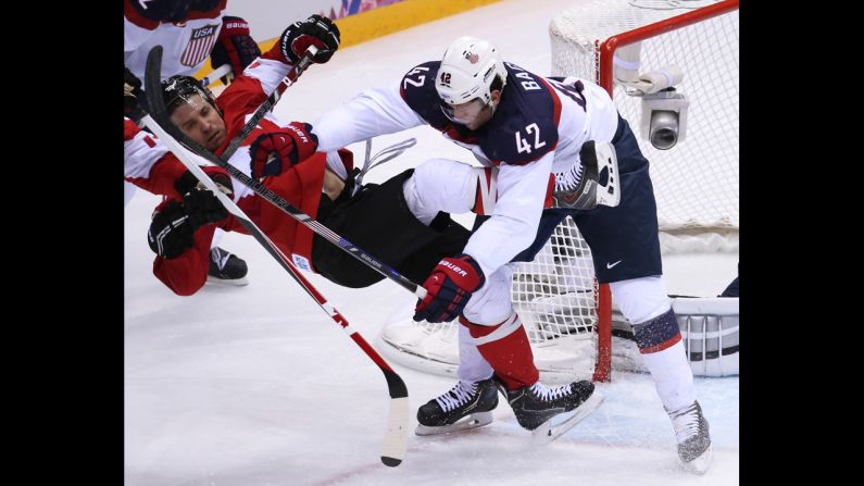 U.S. forward David Backes hits Canada's Patrick Sharp on February 21.